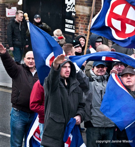 Waving Nazi /neo-Nazi 'sunwheel" flags,right wing extremist groups at an Anti-Immigration anti-refugee Rally organized by the National Front Dover Kent Jan 30th 2016